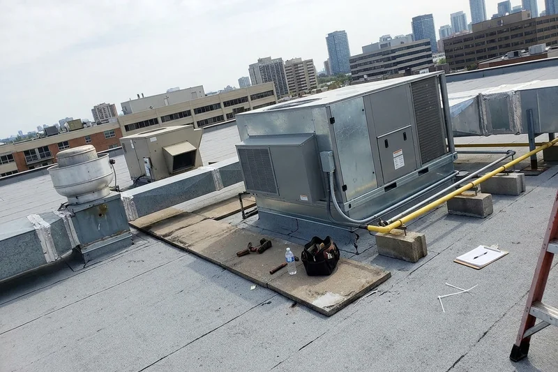 New rooftop unit beside kitchen exhaust equipment